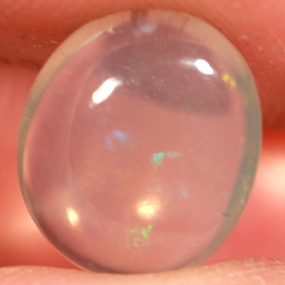 SOLID CRYSTAL OPAL Transparent with green and purple moving within